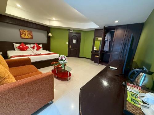 a living room with a bed and a couch at The Great Residence Suvarnabhumi Airport in Lat Krabang