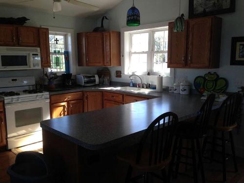 eine Küche mit einer Kücheninsel mit einer Arbeitsplatte in der Unterkunft Bayfront Cottage Rental with a Private Beach on Virginia's Eastern Shore in Onancock