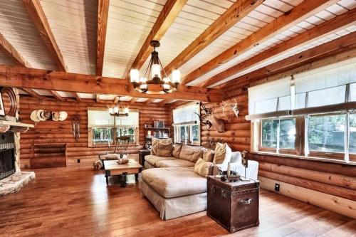 a living room with a couch and a fireplace at Amazing Log Cabin Rental with Pool for a Family Vacation in Florida in Selhaven