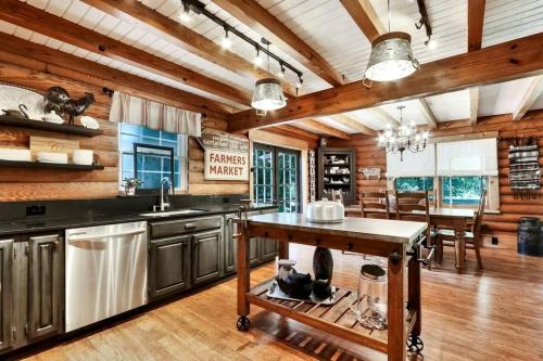 a kitchen with wooden ceilings and a dining room at Amazing Log Cabin Rental with Pool for a Family Vacation in Florida in Selhaven