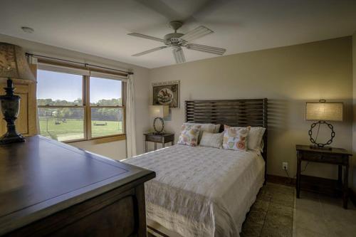 ein Schlafzimmer mit einem Bett mit Deckenventilator in der Unterkunft Amazing Cabin Rental on 22-Acre Horse Farm near Tryon International Equestrian Center, South Carolina in Gowensville