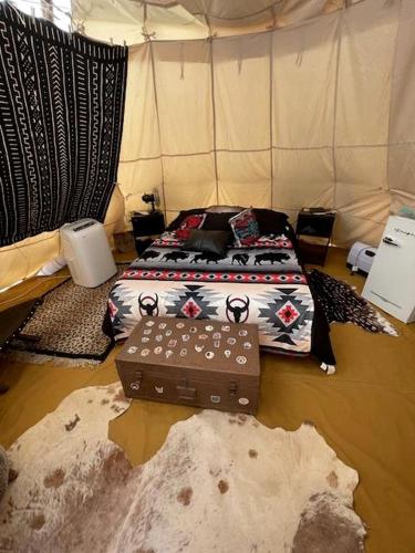 a bedroom with a bed with a bed frame with a bed sqor at Spacious Tipi with Outdoor BBQ and Fire Pit in Texas in Marble Falls