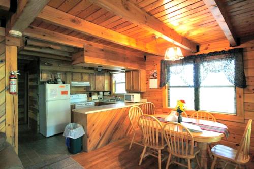 une cuisine et une salle à manger avec une table et des chaises dans l'établissement Stunning Pet-Friendly Cabin Rental near Charleston, West Virginia, à Hico