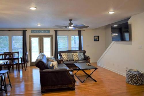 a living room with leather furniture and a dining room at Group Getaway by the Lake: Pet-Friendly Rental with Boat Dock in Picturesque Cullman County in Bremen