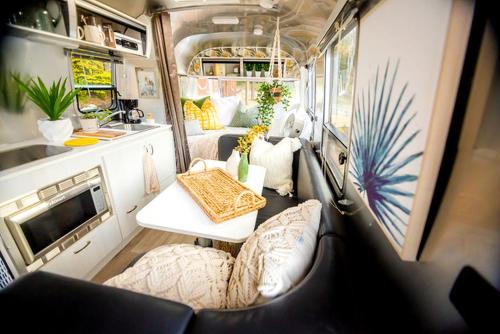 an interior view of an rv with a table and chairs at Beautiful Airstream Glamping Site for Romantic Weekends Away in North Carolina in Jonas Ridge