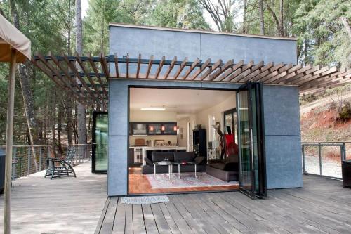 a modern house with a pergola on a deck at Stunning and Secluded Lakeside Getaway in the Grass Valley of California in Pinecrest
