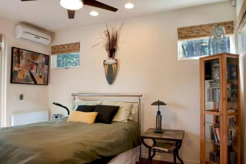 a bedroom with a bed with a plant on the wall at Stunning and Secluded Lakeside Getaway in the Grass Valley of California in Pinecrest