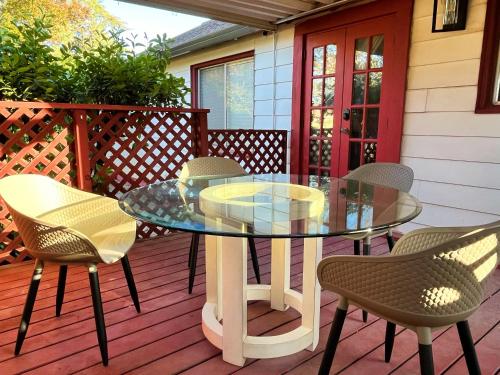 a glass table and chairs on a deck at Cozy Suite with Patio and Gated Parking 12-min Drive to Discovery Park in Sacramento