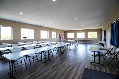 an empty room with tables and chairs in a classroom at Fantastic Secluded Tented Cabin with Fire Pit in Logan, Ohio in Logan