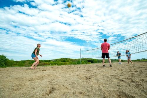 a group of people playing a game of volleyball at Fantastic Secluded Tented Cabin with Fire Pit in Logan, Ohio in Logan