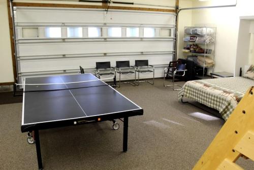 a ping pong table in a room with a bed at Mountain View Cabin with Deck, Jacuzzi and Ping Pong Table in Montana in West Glacier