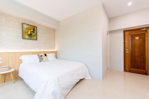 Postel nebo postele na pokoji v ubytování Bailuwar Anping B&B 預訂後務必連絡民宿再一次確認