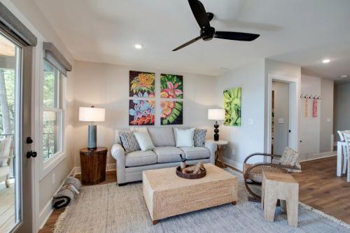 a living room with a couch and a ceiling fan at Magical Family Cabin with Breathtaking Beauty and Modern Interior in Alabama in Grant