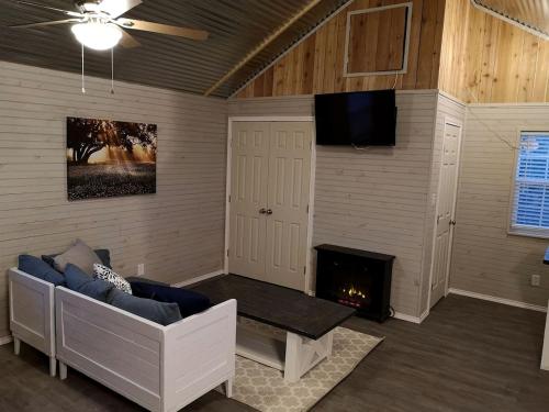 a living room with a couch and a fireplace at Romantic Granbury Cabin Ideal for a Texas Getaway in Tolar