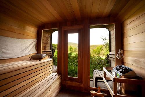 a room with a sauna with a bench and a window at Off-Grid Rustic Glamping Experience Ideal to Reconnect in NY in Roxbury