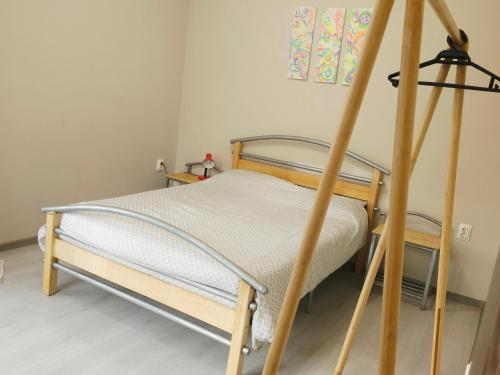 a bed in a room with a wooden frame at Lina Gio Apart in Karlovo