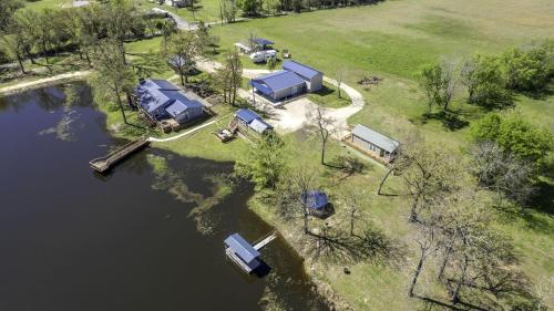 an aerial view of a house on the water at Intimate Chic Cabin Suitable for Four with Private Deck in Texas in Emory