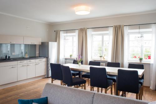 a kitchen and dining room with a table and chairs at Wailtl Hotel in Dorfen