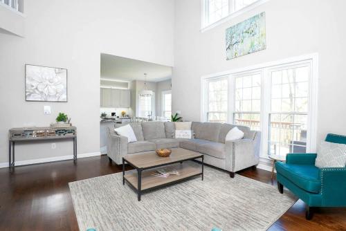 a living room with a couch and a table at Disconnect at this Cottage with Great Surroundings in Charlotte, North Carolina in Charlotte
