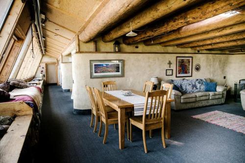a dining room with a table and chairs and a couch at Unique and Modern Lodging with Exceptional Features in Paradise Valley, Montana in Flying Y Ranch Airport