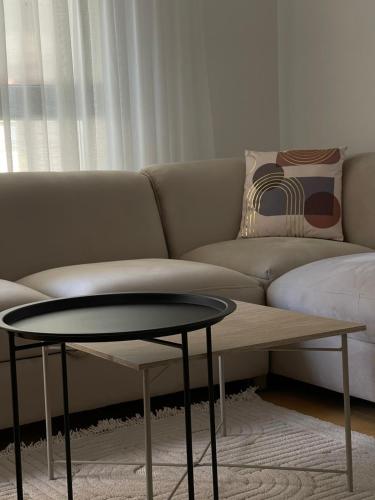 a living room with a couch and a table at Breeze Stay Apartman in Bijelo Polje