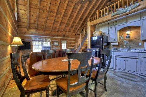 a dining room with a wooden table and chairs at Spacious and Rustic Cabin with a Hot Tub near Copperhill for a Family Getaway in Tennessee in Copperhill