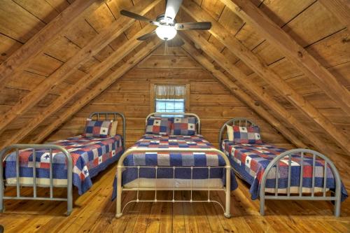three beds in a room in a log cabin at Spacious and Rustic Cabin with a Hot Tub near Copperhill for a Family Getaway in Tennessee in Copperhill