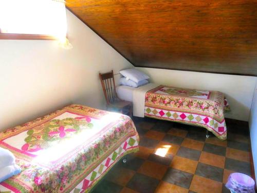 a small room with two beds in a room at Lakefront Cabin Rental with Incredible Sunsets on Lake Wallenpaupack, Pennsylvania in Tafton