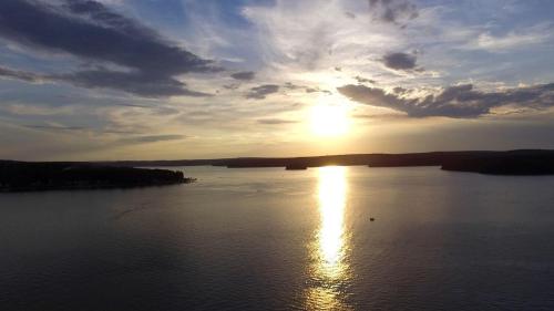 a sunset over a large body of water at Lakefront Cabin Rental with Incredible Sunsets on Lake Wallenpaupack, Pennsylvania in Tafton