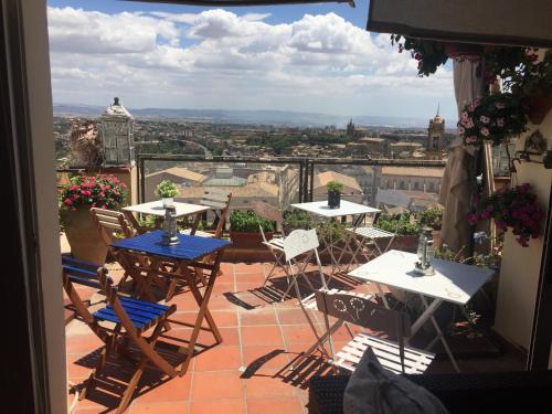 a balcony with tables and chairs and a view of the city at Casa tipica siciliana patronale home BedandBreakfast TreMetriSoprailCielo Camere con vista, colazione interna in terrazzo panoramico in Caltagirone