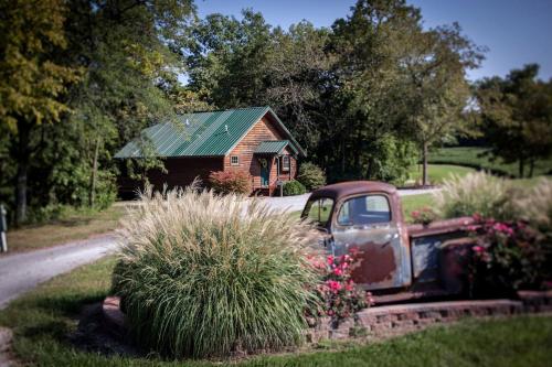 an old truck parked in front of a house at Lakefront Cozy Cabin with Hot-tub in Carbondale, Illinois in Etherton