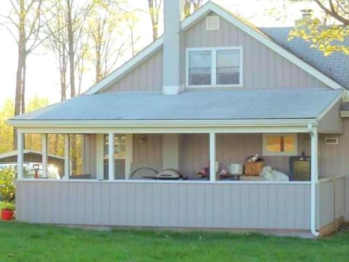 a house with a screened in porch at Peaceful Cabin Rental for Groups on a Farm near Susquehannock State Forest, Pennsylvania in Short Run