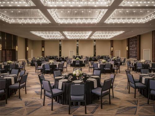 a banquet hall with tables and chairs and lights at The Starling Atlanta Midtown, Curio Collection by Hilton in Atlanta