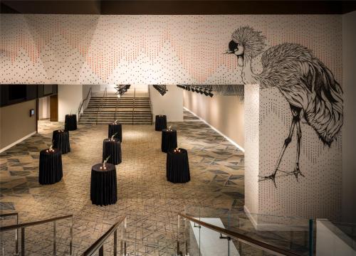a mural of a peacock on the wall of a lobby at The Starling Atlanta Midtown, Curio Collection by Hilton in Atlanta