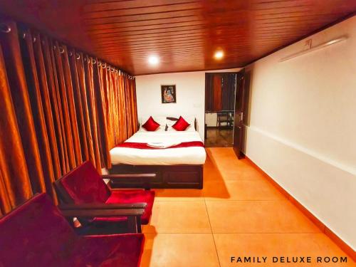 a bedroom with a bed and a chair in a room at Casa Linda in Devikolam