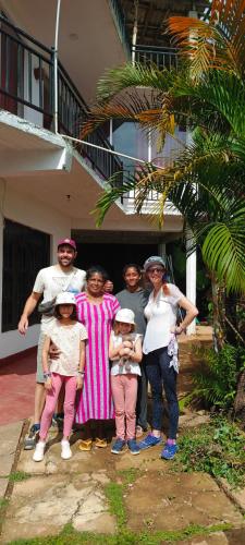 a group of people standing in front of a house at Adisham village home in Haputale