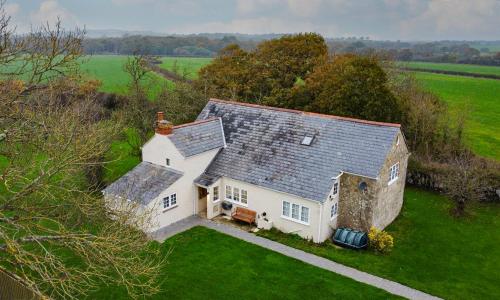 an aerial view of a large white house in a field at Colemans Retreat in Porchfield