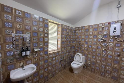 a bathroom with a toilet and a sink at Inapan Taman Herba in Kepala Batas