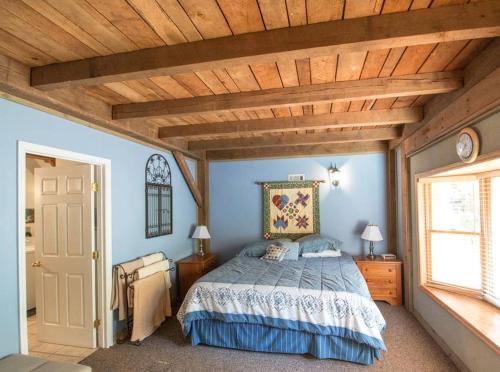 a bedroom with a bed and a wooden ceiling at Delightful Vacation Rental for Group Getaway in Polk County, Tennessee in Reliance