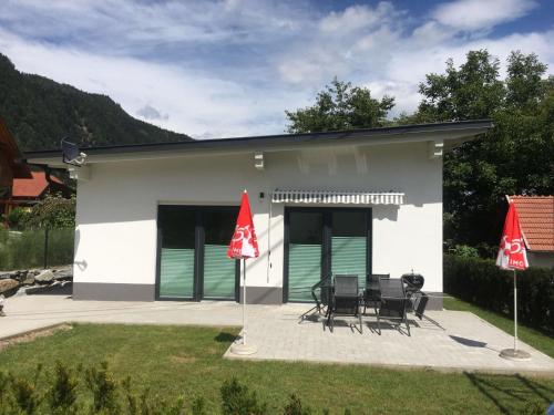 a house with two red flags in front of it at Ferienhaus Silja in Steindorf am Ossiacher See
