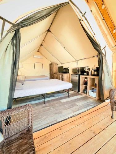 a mattress in a tent in a room at Riverside Paradise: Luxurious Safari Tent on the San Marcos River near Kingsbury, Texas in Staples