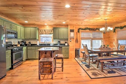 a kitchen with green cabinets and a wooden floor at Incredible Cabin with Fireplace and Hot-tub Next to Hiking Trails in Mineral Bluff, Georgia in Mineral Bluff