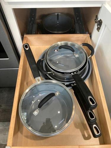a set of pans in a drawer with a knife at Lake Cabin Ideal for Outdoor Adventures in Maine in North Harpswell