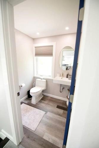 a bathroom with a toilet and a sink and a mirror at Lake Cabin Ideal for Outdoor Adventures in Maine in North Harpswell