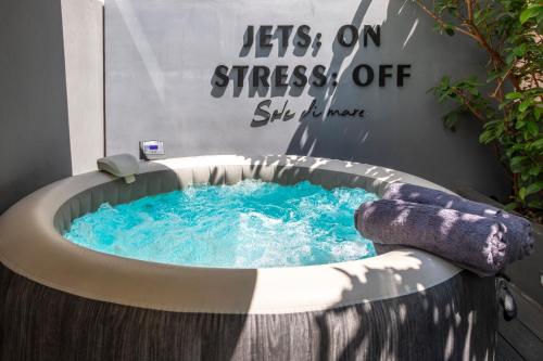 a hot tub with a water slide in a room at Aqua Bliss Piraeus in Piraeus