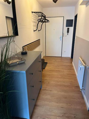 a room with a dresser and a hallway with a door at BergHerz Allgaeu in Sonthofen