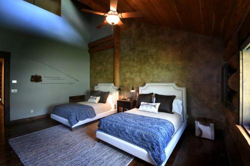 a bedroom with two beds and a ceiling fan at Deluxe Vacation Suite with Private Bathroom in Melrose, Montana in Divide