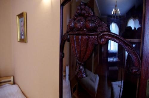 a wooden mirror in a room with a bedroom at Villand Hotel with Free Private Parking and Self Check In in Rīga