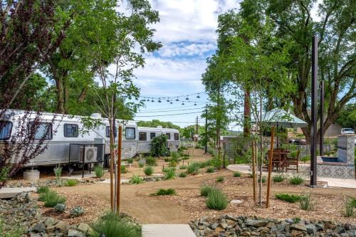 an rv is parked in a garden with trees at Pet-Friendly Airstream Stay Near Whiskey Row in Prescott AZ in Prescott