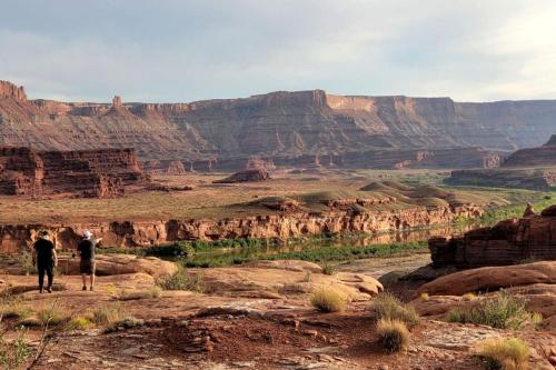 two people standing on the edge of the grand canyon at Luxurious Cave for a Romantic Retreat near Arches National Park in Moab, Utah in Allen Memorial Hospital Heliport